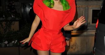 Lady Gaga gets in the festive spirit as she appears as a Christmas tree in front of her hotel in London
