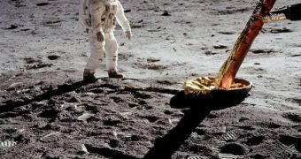 Buzz Aldrin near the leg of his lunar lander, as he inspects for damage