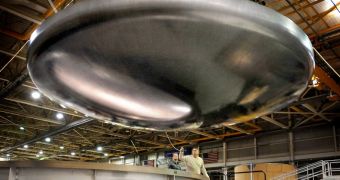 The Orion heat shield structure hovers above its layup mold during removal at the Lockheed Martin composite development facility in Denver, Colorado