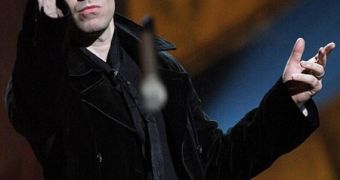 Liam Gallagher throws his award and microphone in the audience at the Brit Awards 2010