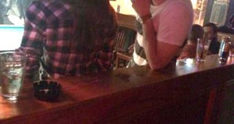 Liam Hemsworth looks in love as he chats with Nina Dobrev in a bar in Atlanta