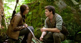 Jennifer Lawrence and Liam Hemsworth in character in “Hunger Games” still