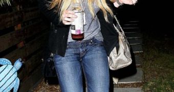 Lindsay Lohan with a container of Kombucha tea, which she’s reportedly using to kick her alcohol addiction