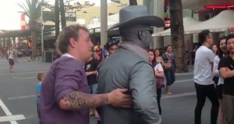 A street performer punches a tourist in the face in Australia
