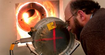 Steve Wender of the Los Alamos Neutron Science Center at LANL examines the fission ion chamber used to measure the number of neutrons that pass through
