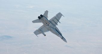 A NASA Dryden Flight Research Center F/A-18 aircraft performs a roll during a dive toward Rogers Dry Lake at Edwards Air Force Base, during June flight tests of the MSL landing radar