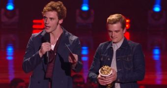 Sam Claflin and Josh Hutcherson receive the Movie of the Year Award for “The Hunger Games: Catching Fire”