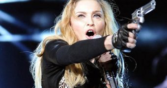 Madonna says the fake guns she uses in concerts are just metaphors, she doesn’t “condone violence”