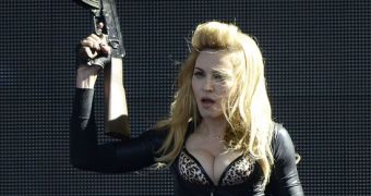 Madonna waves a fake machine gun on one of her M.D.N.A. shows
