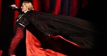Madonna is yanked down some stairs by her Armani cape at the Brit Awards 2015
