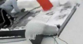 A funny video shows a man taking a tumble while shoveling snow off his roof
