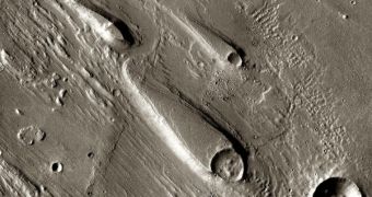 In the Ares Vallis region of Mars, teardrop mesas extend like pennants behind impact craters