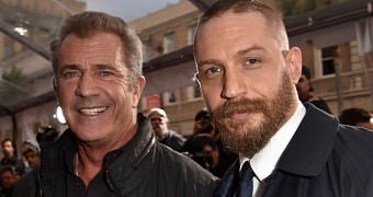 Mel Gibson and Tom Hardy pose for pictures together at the LA premiere of “Mad Max: Fury Road”