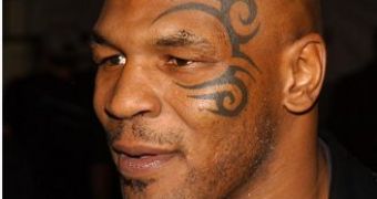 Mike Tyson is booked for assault on paparazzo, which may constitute violation of his probation terms