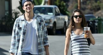 Mila Kunis showing signs of a baby bump just weeks after announcing her engagement to Ashton Kutcher