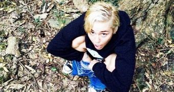 Miley Cyrus reaches new lows while sharing a photo of her squatting in the forest