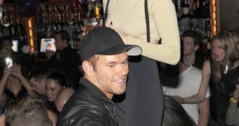 Kellan Lutz and Miley Cyrus share a loving embrace despite denying they are dating