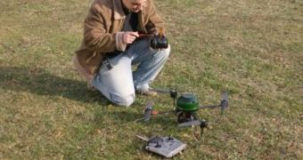 A German researcher tweaks the controls for a prototype quadrocopter, pictured to the right