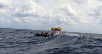 Engineers rush to capture the orion Crew Exploration Vehicle, as it drifts in the Atlantic ocean waters off the coast of Florida