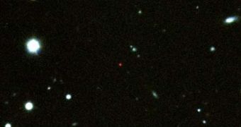 GRB 090423 is the small, very red source in the center of this image. All its visible light wavelengths have long since been absorbed, and only IR light remains