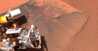 Spirit snaps a shot of its front right wheel, jammed in a rock it came across on the Martian surface