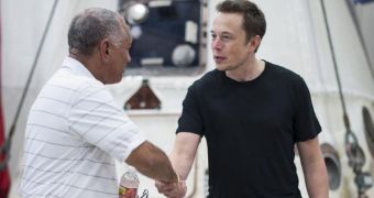 Backdropped by the Dragon capsule, NASA Administrator Charles Bolden and SpaceX CEO, Elon Musk, meet in McGregor, Texas