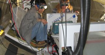 Broadband lidar instrument team members Wen Huang and Elena Georgieva test the performance of their laser in the belly of the DC-8 airborne test platform