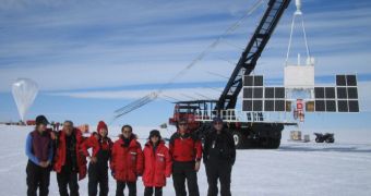 The CREAM VI team is seen here posing with the balloon, right before launching it above Antarctica