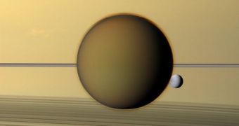 This is the largest moon in the solar system, Titan, seen here with Dione, and Saturn in the background