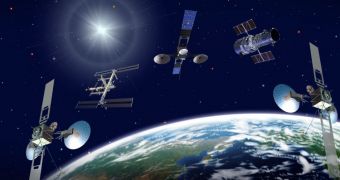 Three TDRS satellites, the International Space Station (ISS) and Hubble Space Telescope orbit a blue-green Earth in this artist's concept