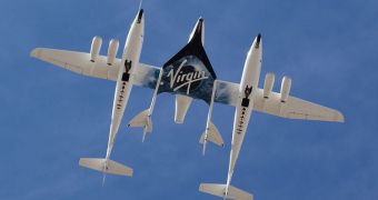 This image shows the SpaceShipTwo (with black Virgin Galactic logo on its belly) underneath the WhiteKnightTwo carrier aircraft
