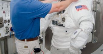 STS-130 Mission Specialist Nicholas Patrick participates in an Extravehicular Mobility Unit, or EMU, spacesuit fit check, assisted by Commander George Zamka