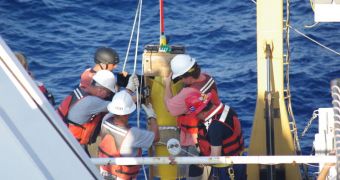 Personnel aboard the NOAA Ship Thomas Jefferson prepare to launch a Naval Oceanographic Office glider as part of a Gulf of Mexico Loop Current research cruise