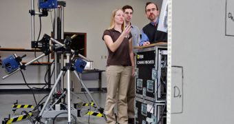 Purdue professor Douglas Adams, at right, doctoral student Sara Underwood and graduate student Matt Houtteman review data using a three-dimensional laser vibrometer