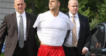 NFL Aaron Hernandez is placed in handcuffs and taken into custody, charged with the murder of Odin Lloyd