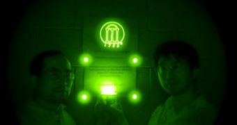 Pan and Liu stand in a darkened room, using only their recently invented ceramic discs that emit near-infrared light as a source of illumination