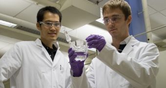 Graduate students Jin Suntivich (left) and Kevin J. May are seen here inspecting the electrochemical cell for their new oxygen evolution reaction experiments