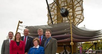 US officials pose with a full-scale model of the James Webb Space Telescope
