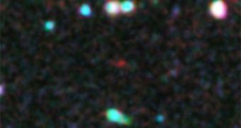 This snapshot from the 2009 Hubble Ultra-Deep Field is revealing a very distant galaxy, possibly the oldest ever detected