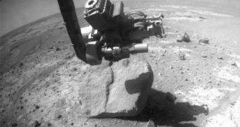 Opportunity investigating Marquette Island on Mars. Peck Bay is seen under the tip of the robotic arm