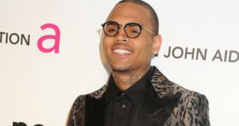 Chris Brown poses for pictures at Elton John’s Oscars 2013 party