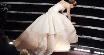 Jennifer Lawrence trips and falls on her way to accept the Oscar for Best Actress