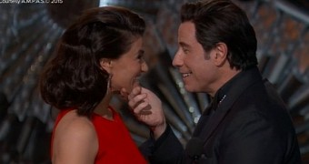 John Travolta gets touchy-feely with Idina Menzel on stage at the Oscars 2015