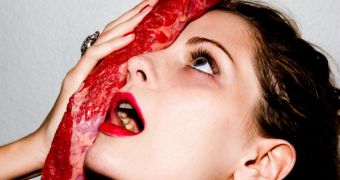 Mischa Barton poses with a piece of raw meat for Tyler Shields