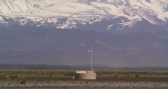One of Auger's 1600 ground detectors is shown in the figure, in front of the Andes mountains in Mendoza, Argentina