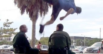A man jumps over cops' heads as they sit on a bench