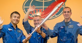 The three astronauts making up half of Expedition 38 to the ISS pose with the Olympic Torch today, November 6, 2013