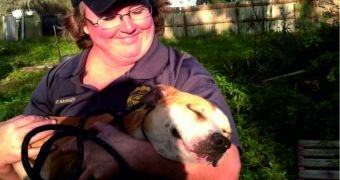 Pam Perry with Hillsborough County Animal Services in Florida is holding a rescued pit bull
