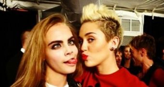 Miley Cyrus and Cara Delevingne share a kiss and some tongue