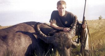 Picture shows Prince Harry smiling next to the dead body of a water buffalo